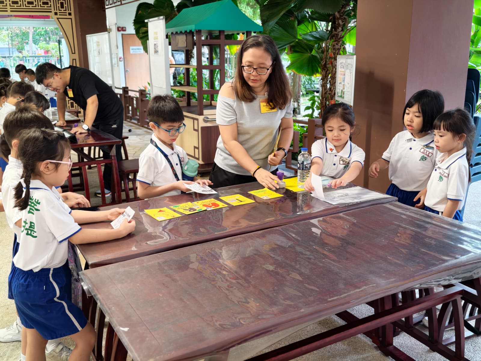 Pupils wearing Maha Bodhi School PE attire actively participating in game station.