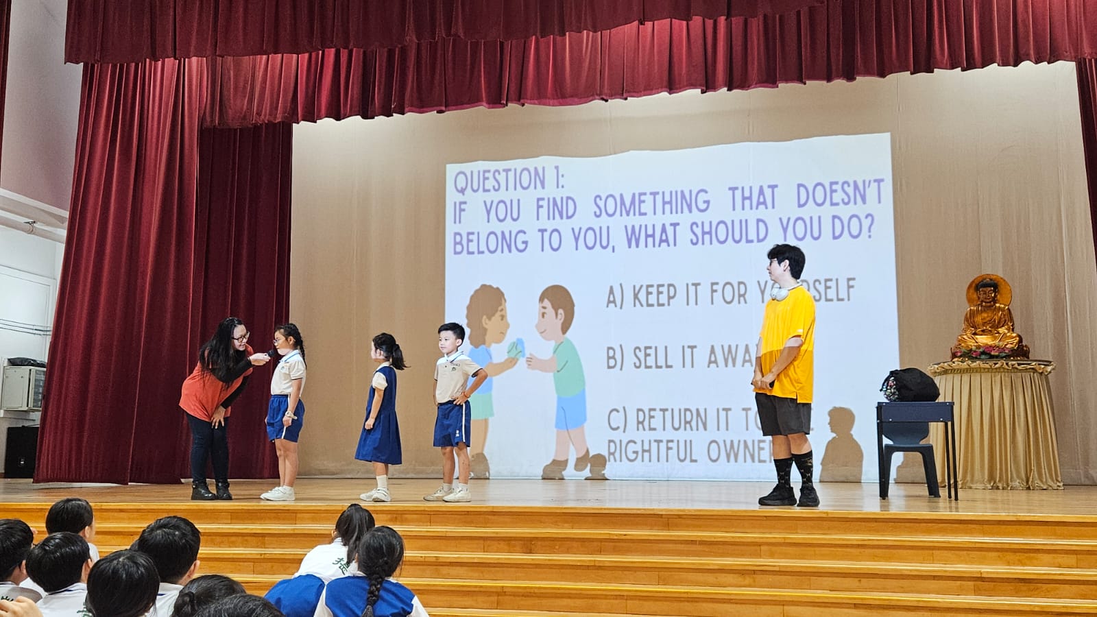 Well Being Week skit on stage with adult and children