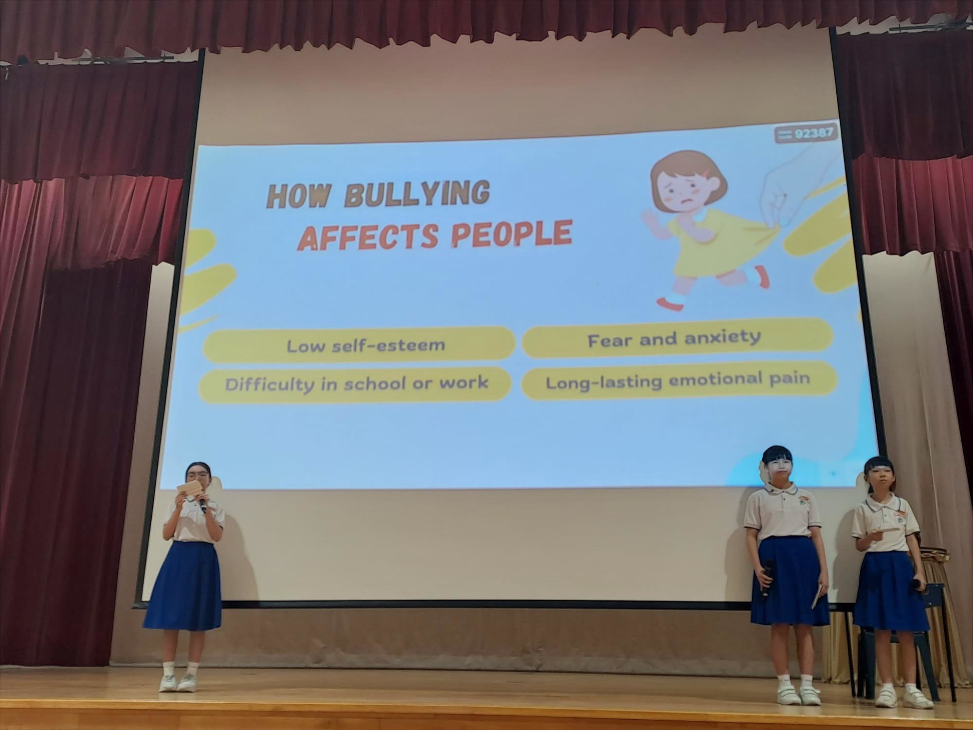 Pupils on stage explaining on how bullying affects people