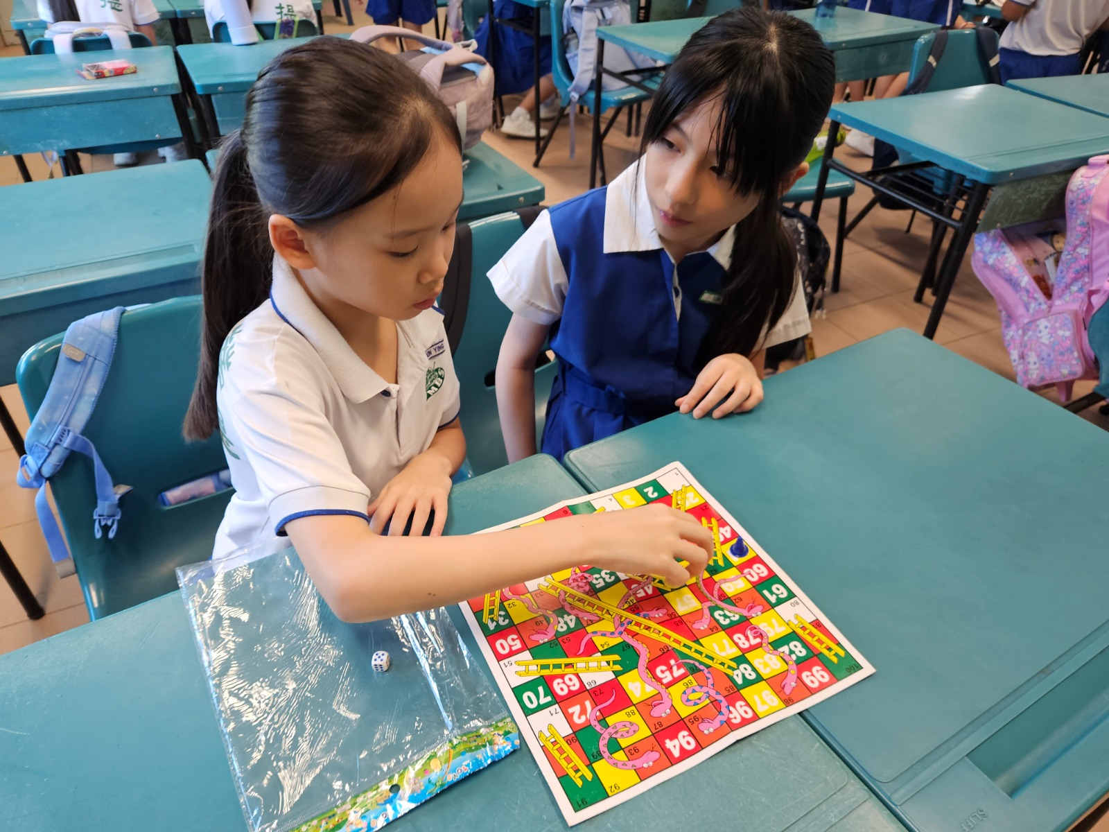 Pupils in school attire bonding through games during Back to School Programme