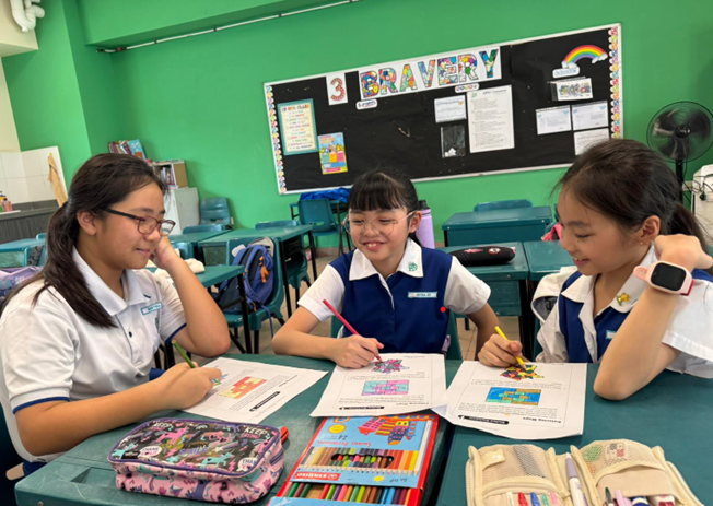 Girls in school uniform doing group work during E2K