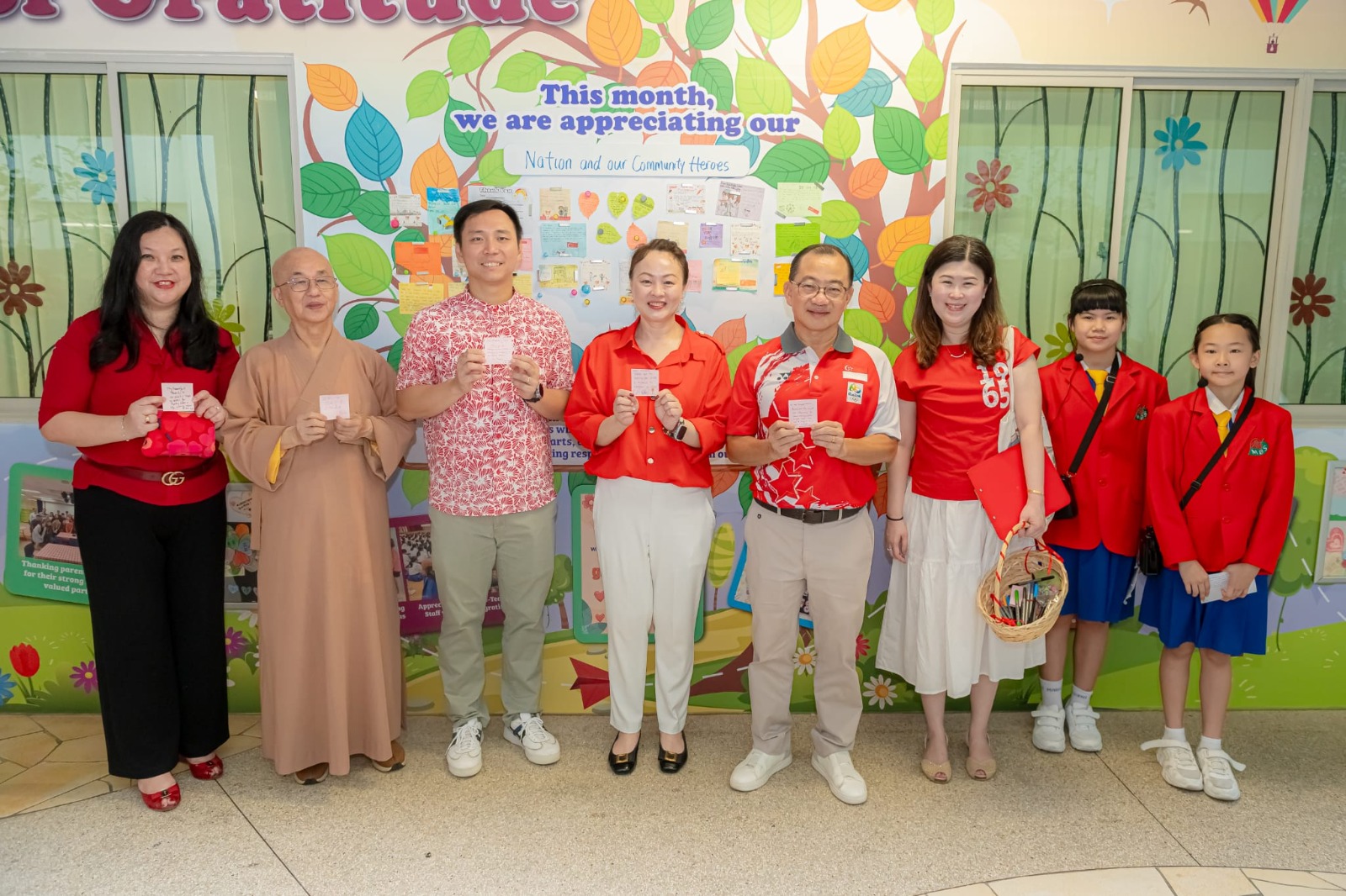Guests of honour and senior school leaders taking group photo in front of Appreciation Board.