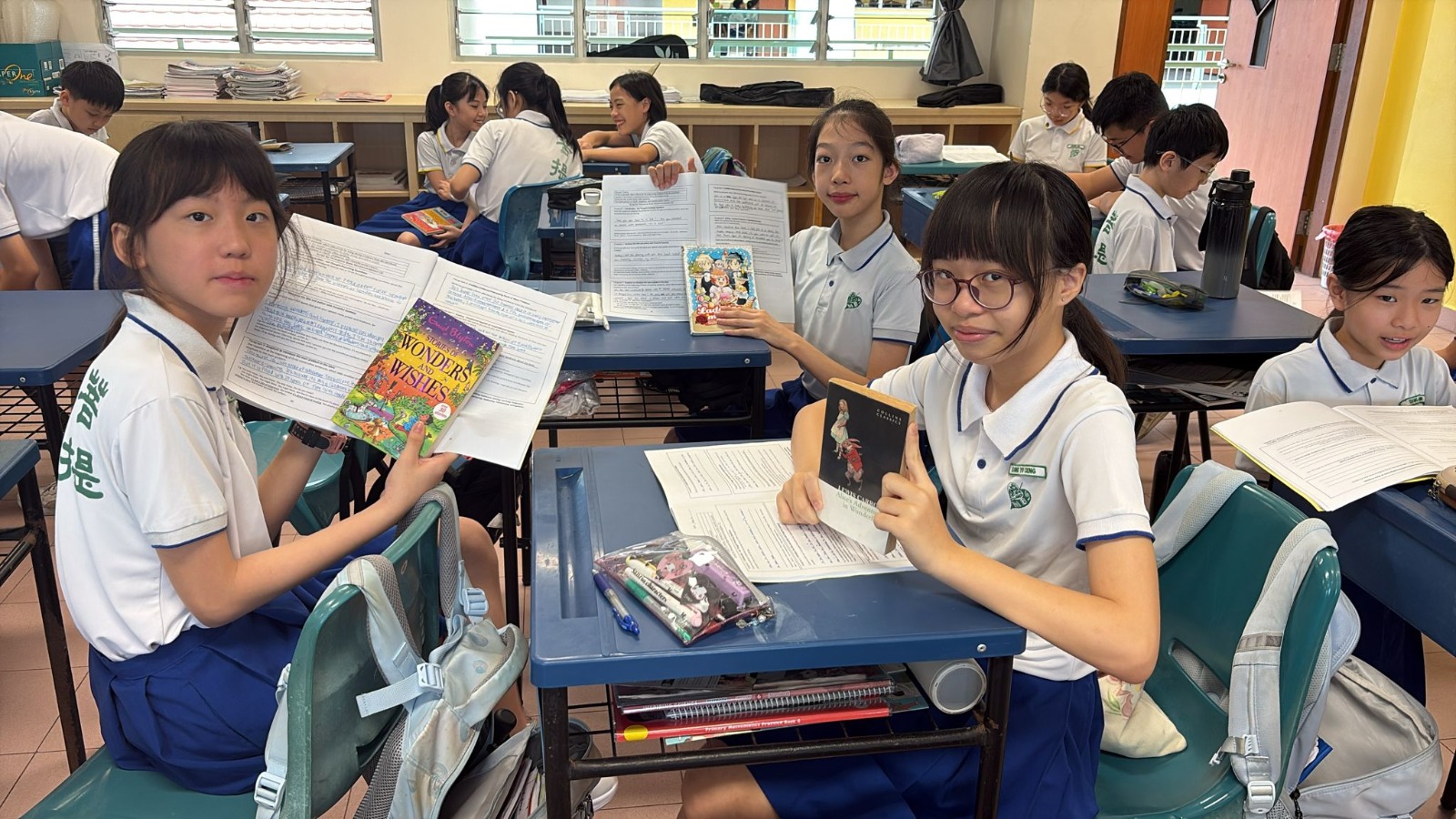 Pupils in class holding on to their reading record and their favourite storybook.