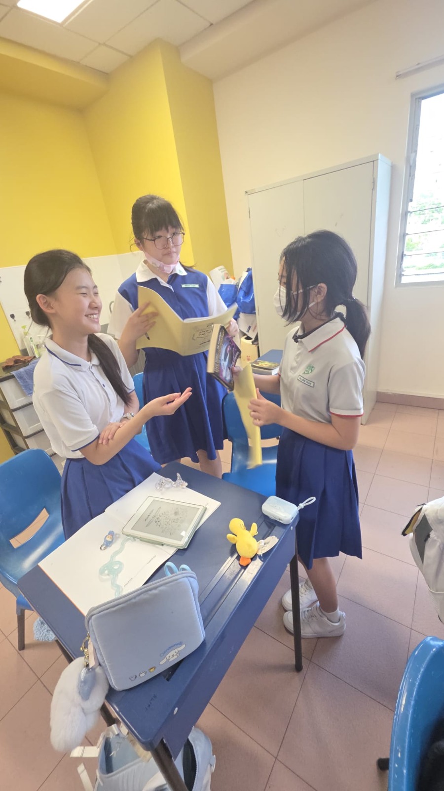 Pupils in class holding on to their favourite storybook and sharing interesting plot in the story.