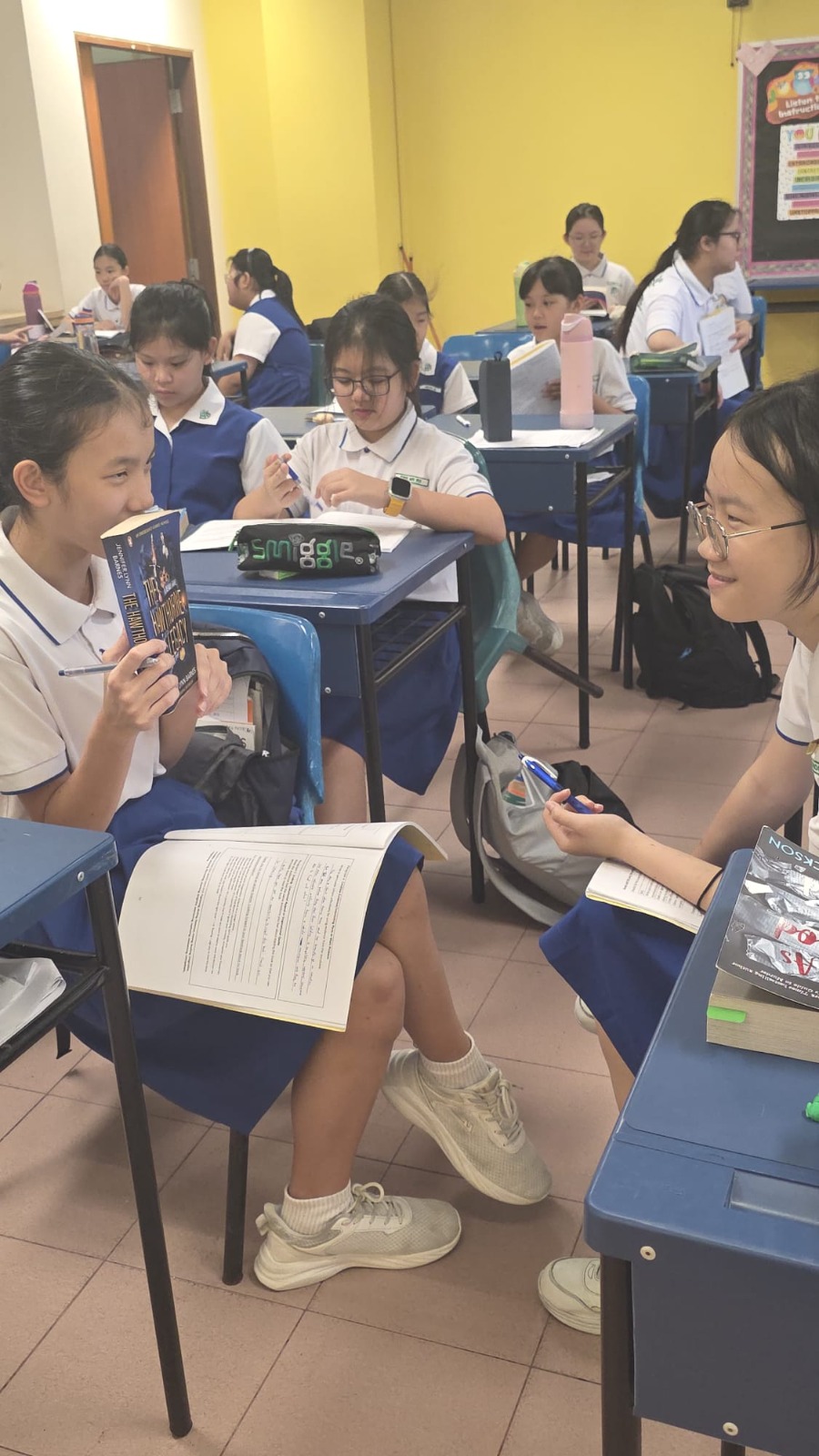 Pupils in class holding on to their favourite storybook and sharing interesting plot in the story.