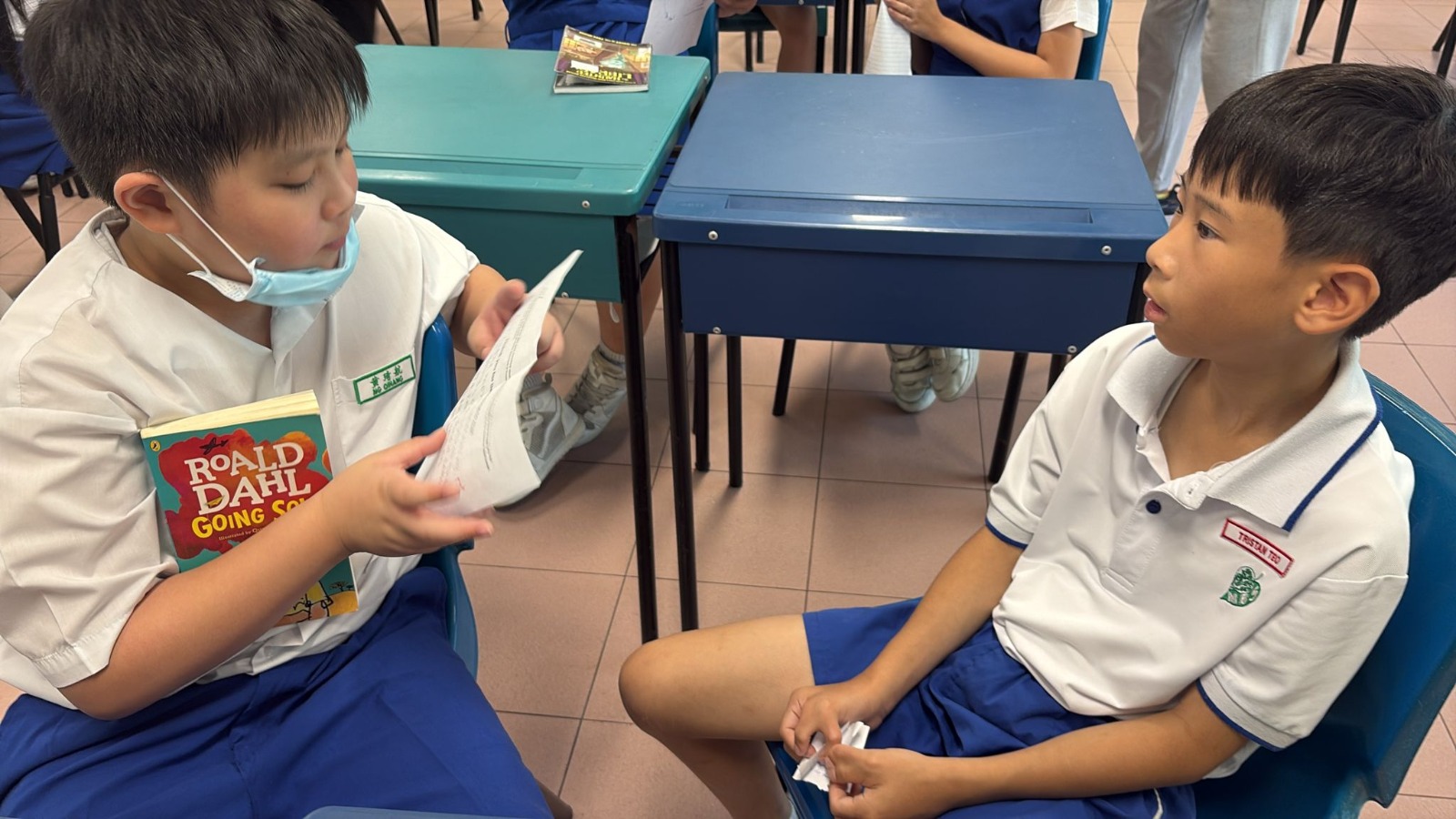 Pupils in class holding on to their favourite storybook and sharing interesting plot in the story.