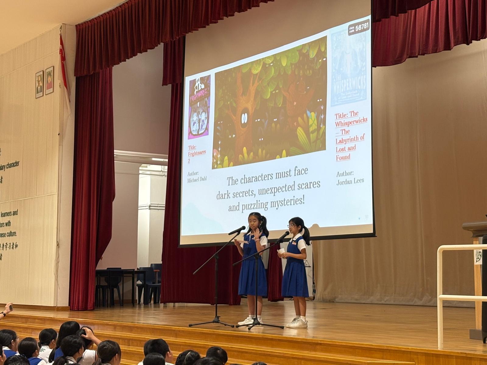Teacher and Pupils in blue and white uniform sharing on their favourite story book during morning assembly.