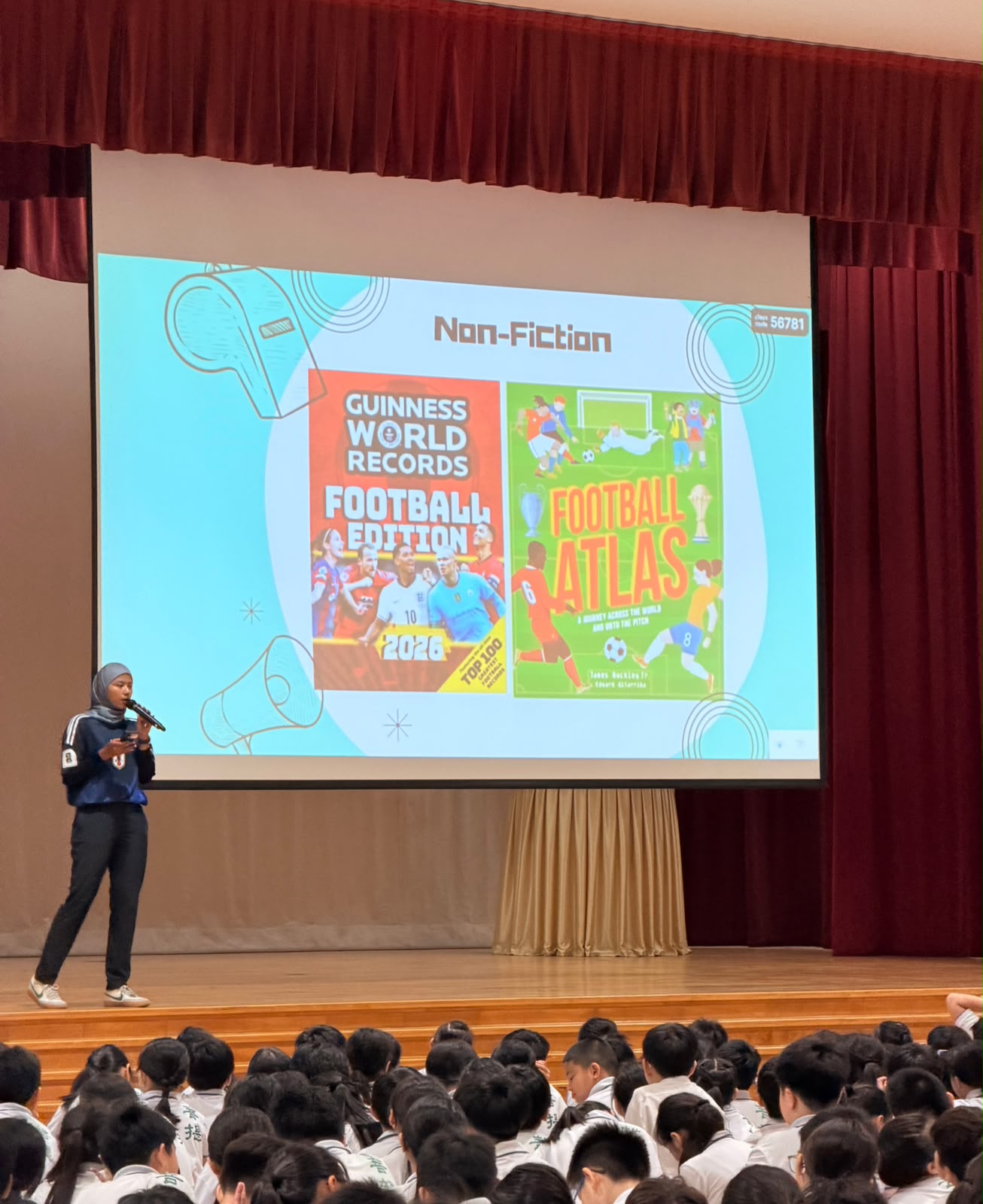Teacher and pupils sharing their favourite story book during assembly.