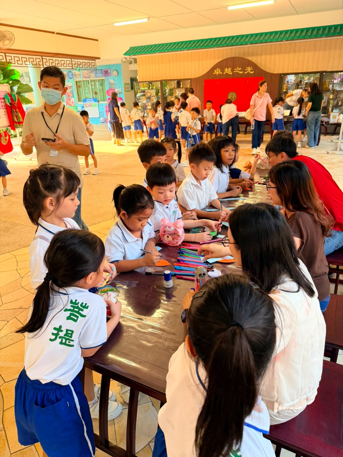 Students learning through games guided by parent volunteers.