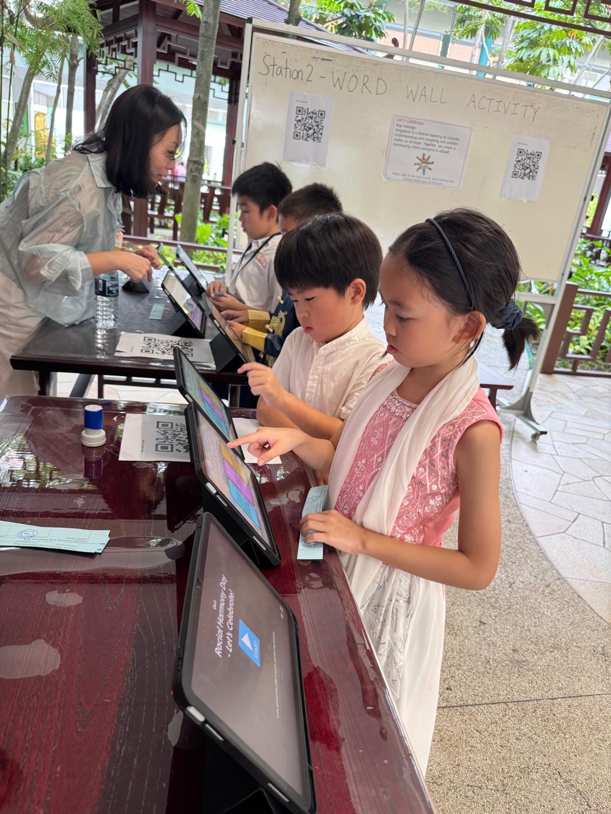 Students learning more on Racial Harmony through iPads.