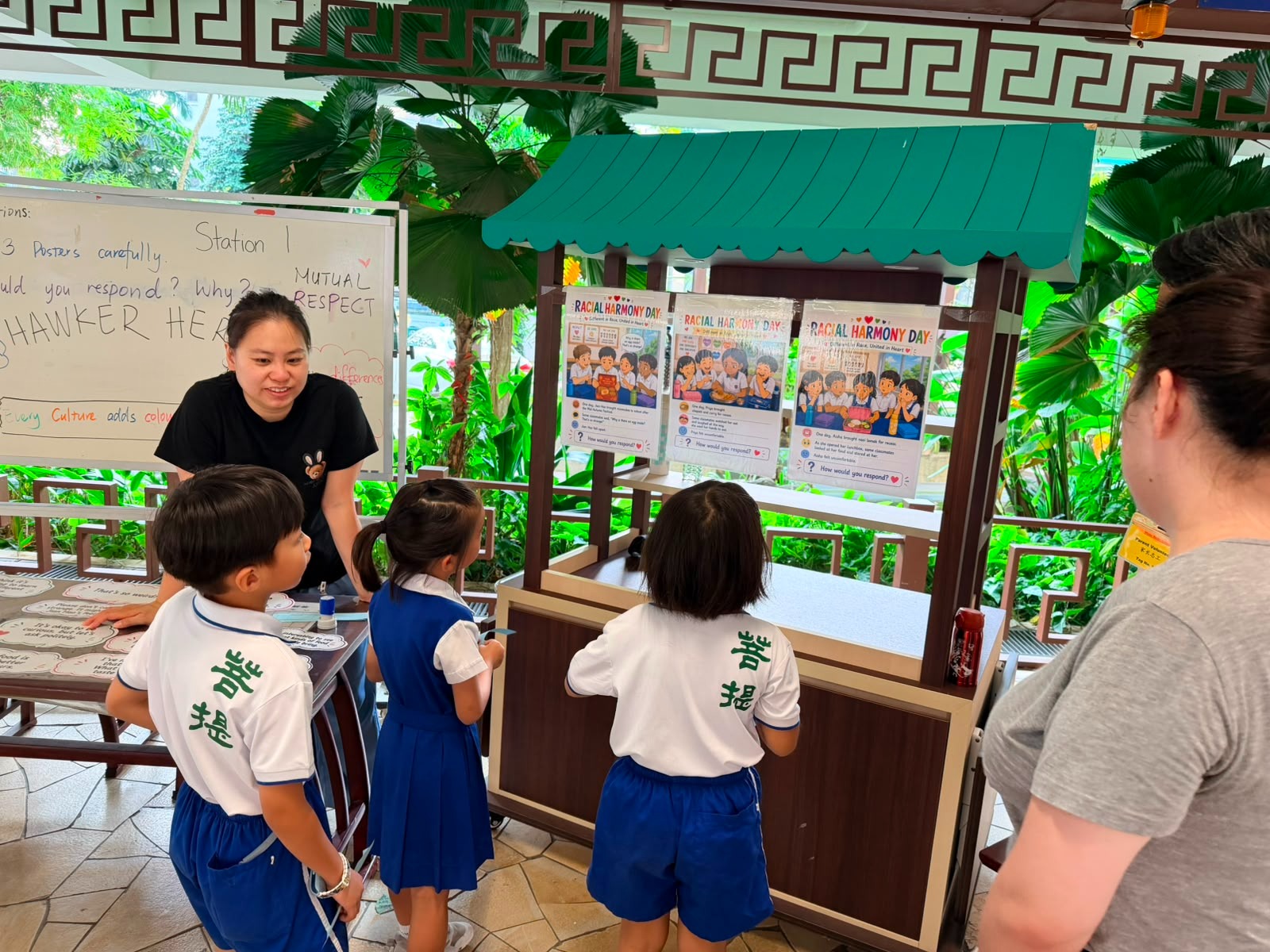 Learning more on racial harmony through booth display guided by parent volunteers.