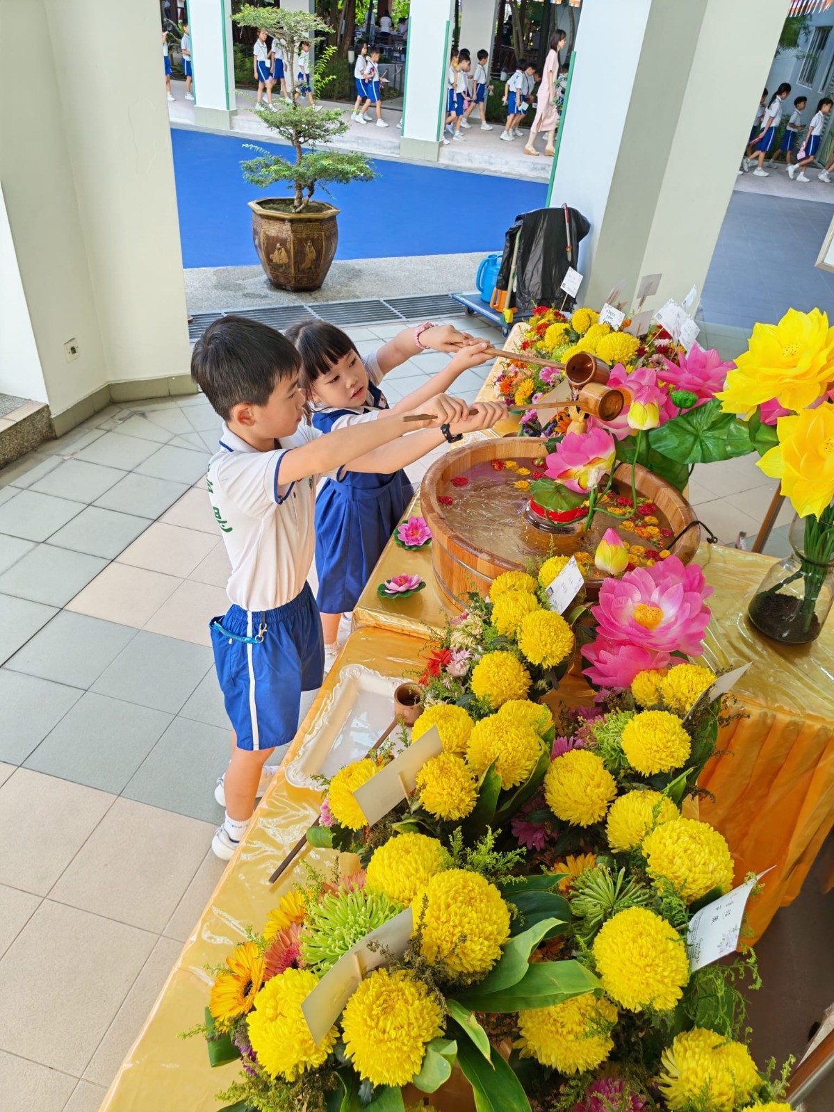 Pupils participating in Buddha Bathing Ceremony