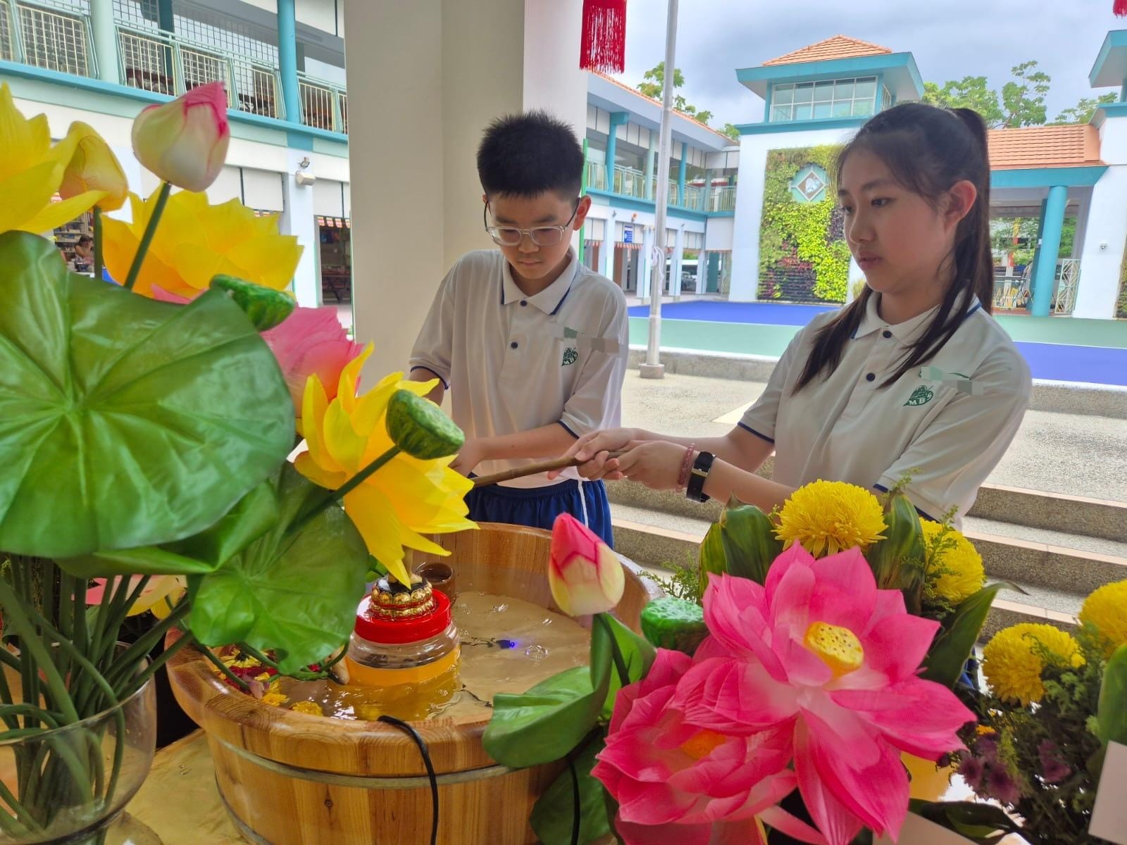Upper Primary Pupils participating in Buddha Bathing Ceremony