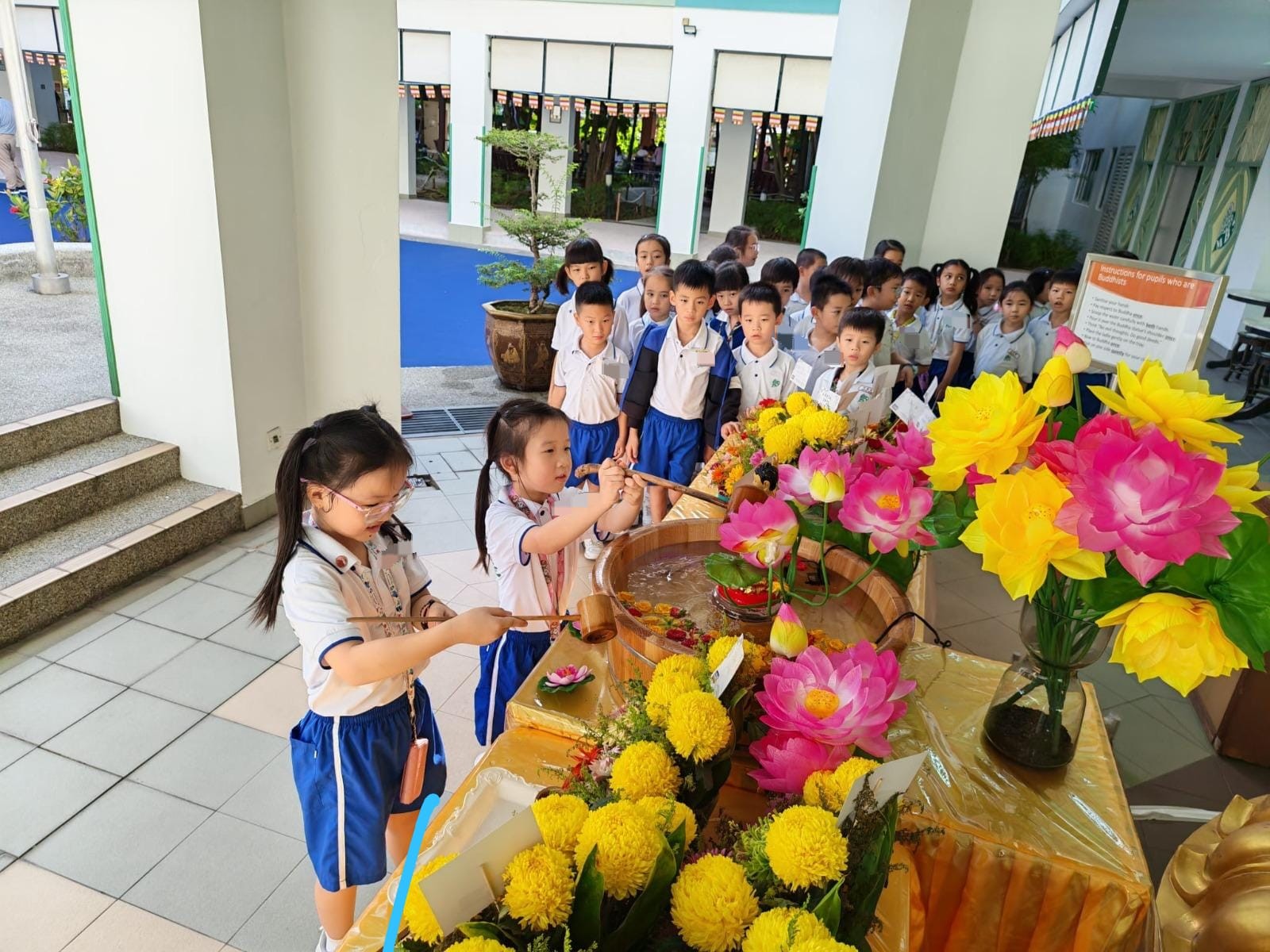 Pupils queueing to participate in Buddha Bathing Ceremony