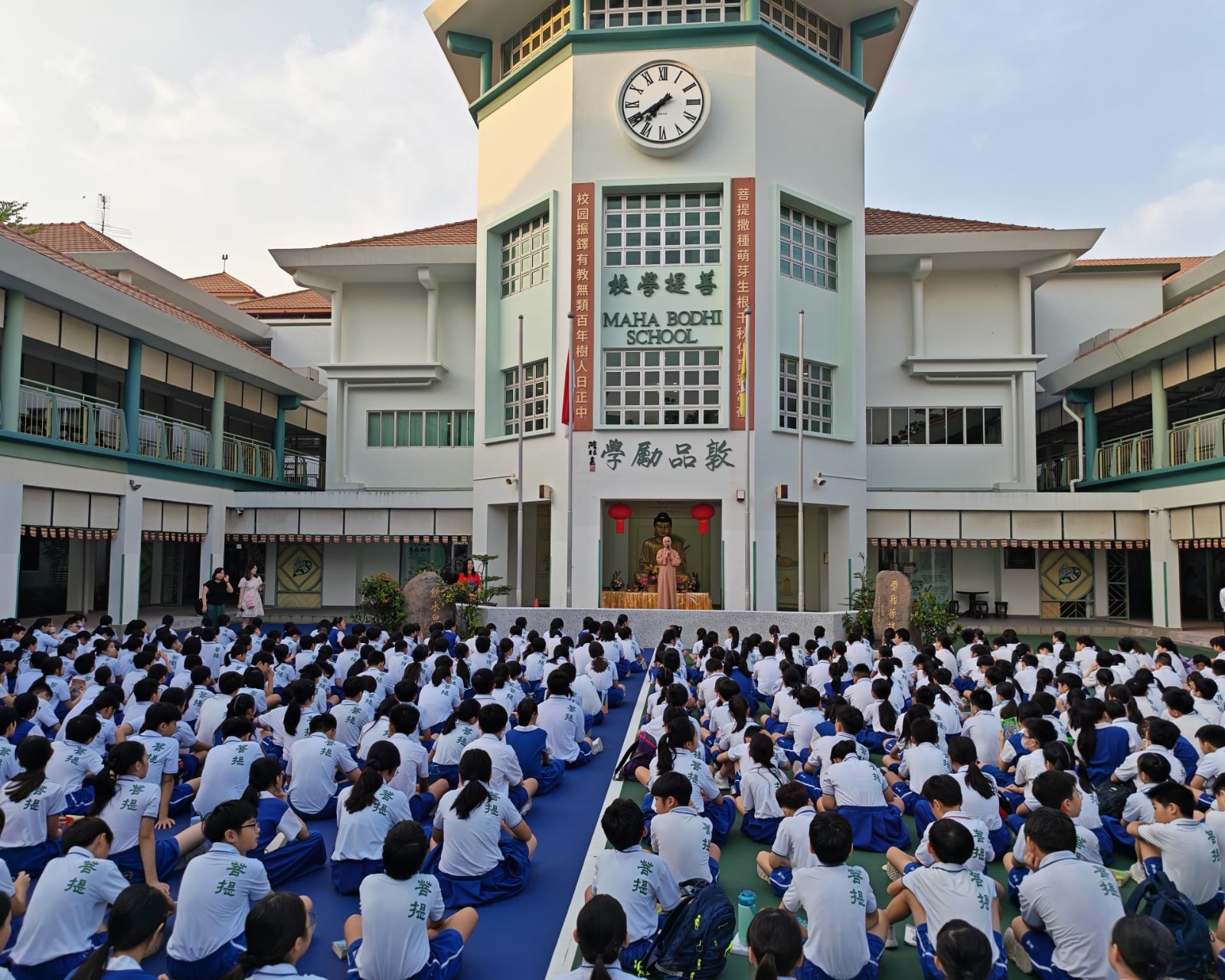 Pupils seating in Parade Square listening to sharing by Venerable Seck Kwang Phing